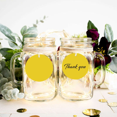 Thank you mason jars with yellow tags and floral decor