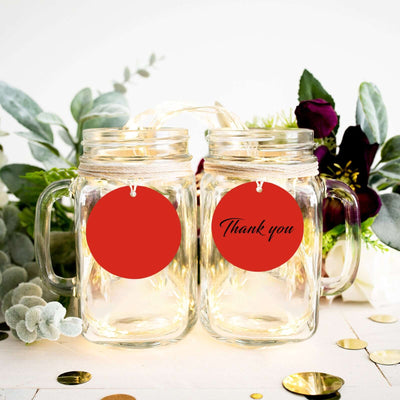 Thank you mason jars with red tags on a decorated table