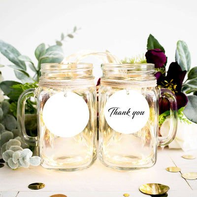 Thank you mason jars with tags and floral decor on a table