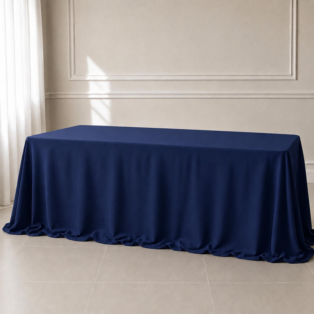 Navy blue rectangular tablecloth draped over an 8ft table in a bright room.