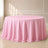 Pink polyester round tablecloth with a seamless finish on a round table.