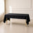 Black polyester rectangle tablecloth on a table in a bright room.