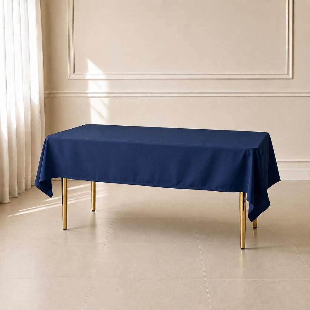 Navy blue polyester rectangle tablecloth on a table in a bright room.