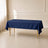 Navy blue polyester rectangle tablecloth on a table in a bright room.