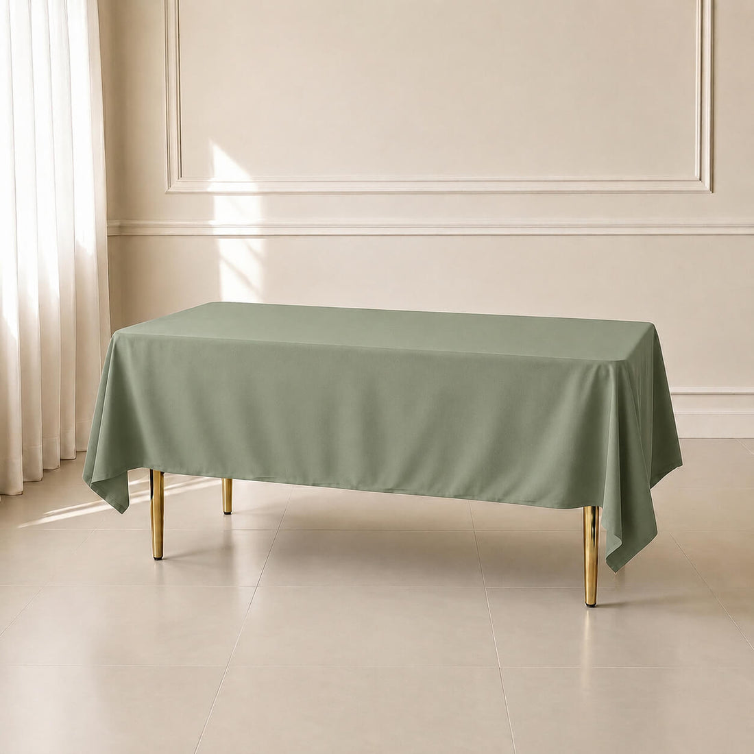Dusty sage green polyester rectangle tablecloth on a dining table.
