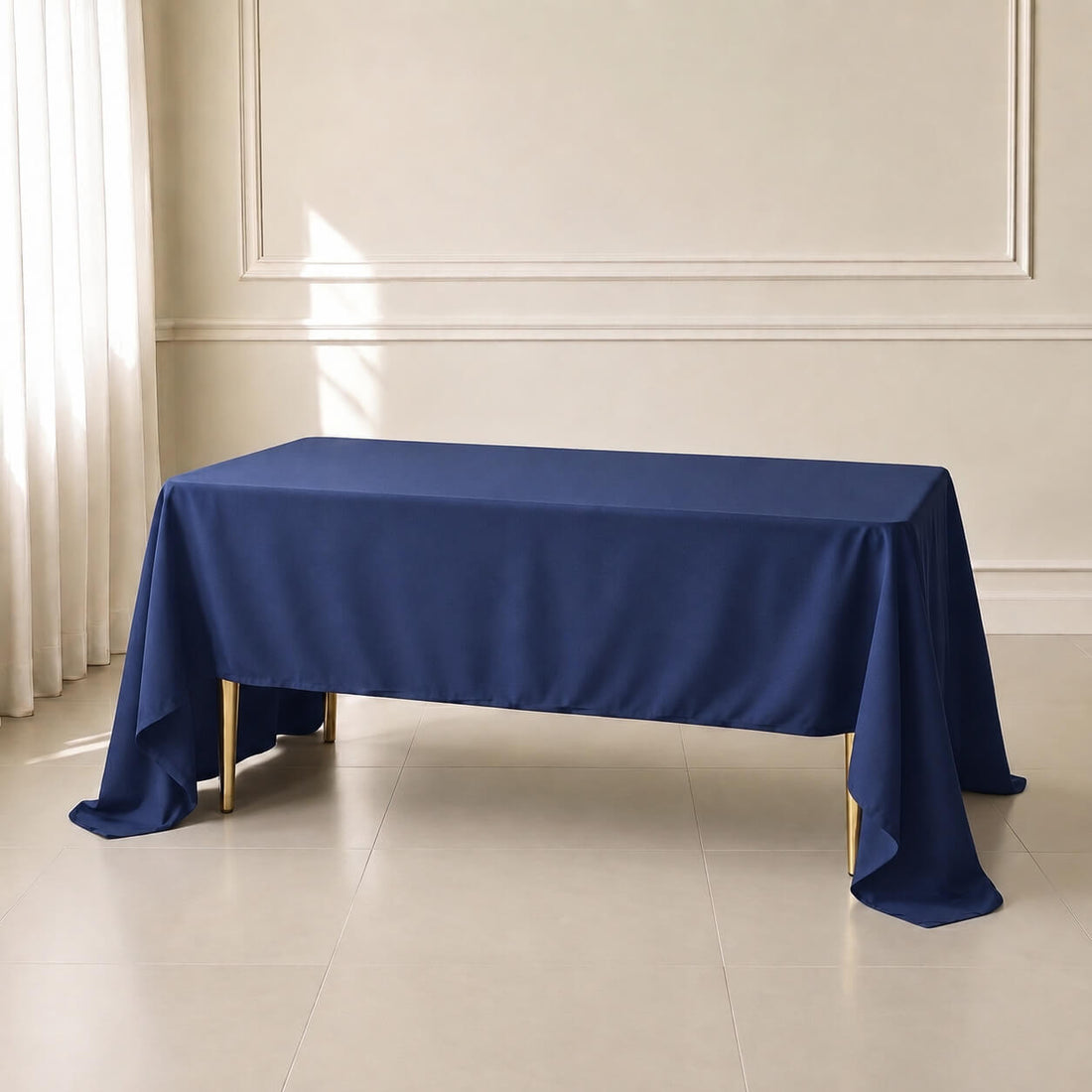 Navy blue rectangle tablecloth on a dining table in a well-lit room.