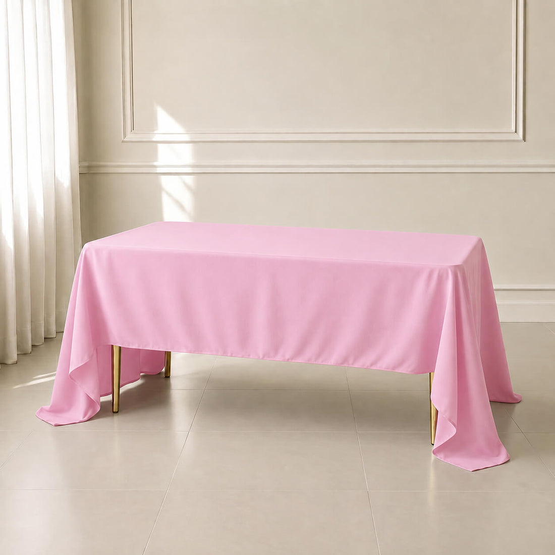 Pink polyester rectangle tablecloth on a wooden table.