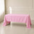 Pink polyester rectangle tablecloth on a wooden table.