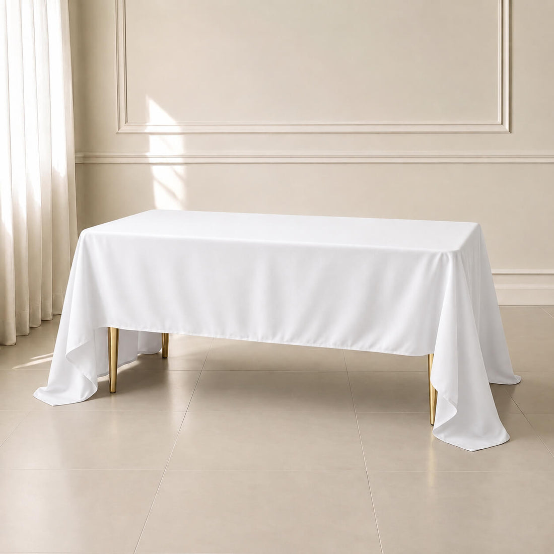 White polyester rectangle tablecloth on a table in an elegant setting.