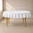 White polyester round tablecloth with linen texture on a table.