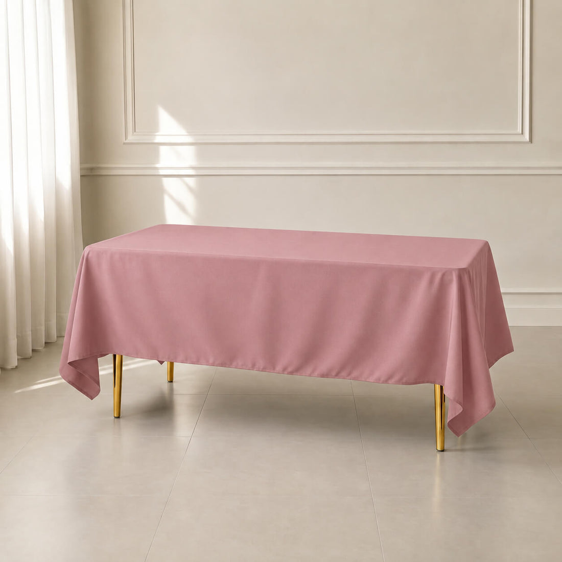 Dusty rose polyester rectangle tablecloth 72"x120" with wrinkle-resistant finish.