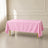 Pink polyester rectangle tablecloth on a dining table.