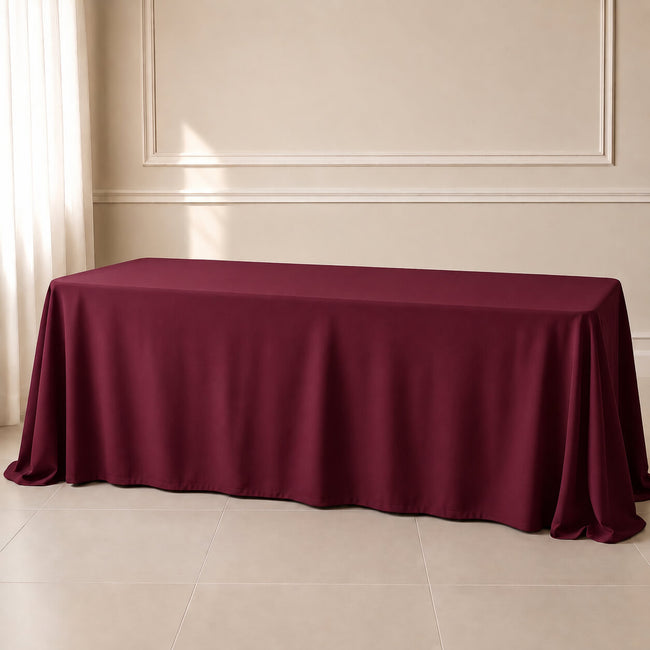Burgundy polyester rectangle tablecloth 90"x156" with seamless finish.