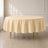 Beige round polyester tablecloth on a dining table.