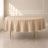 Nude polyester round tablecloth for a durable and reusable table cover.