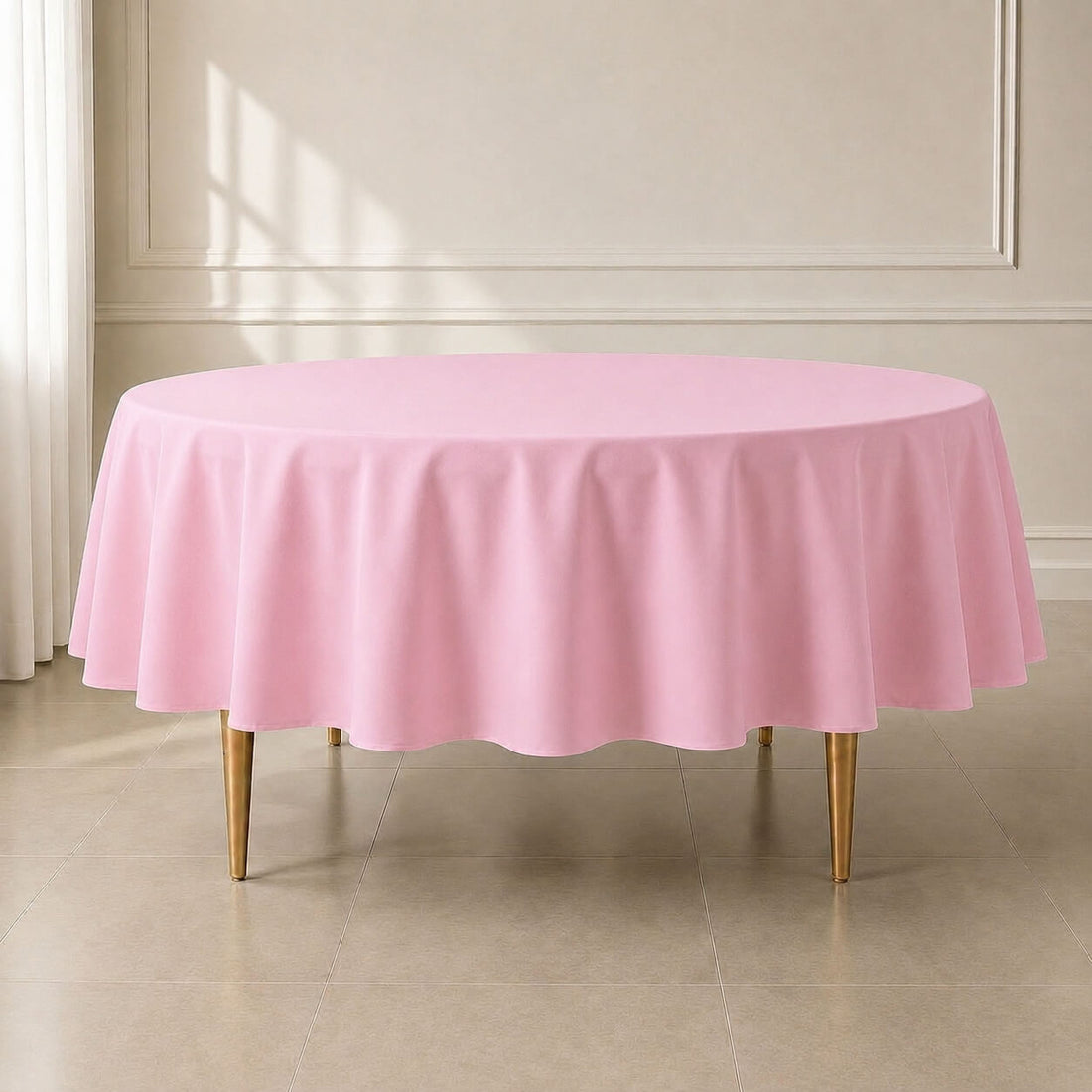Pink polyester round tablecloth for durable and reusable table cover.