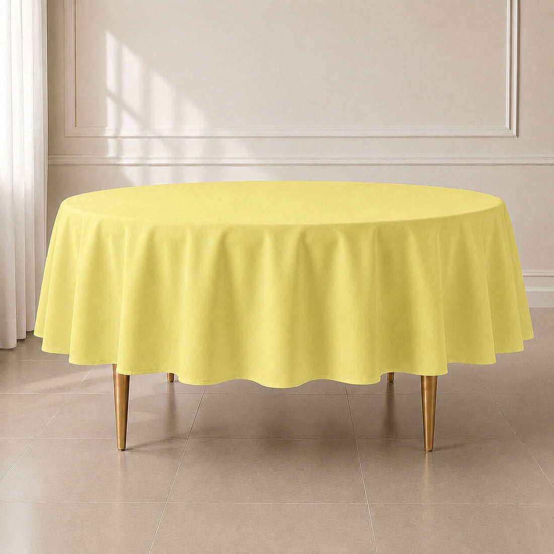 Yellow round polyester tablecloth, 90 inches, reusable and durable.