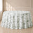 White tablecloth with dusty sage green French toile pattern on a round table.