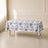 White tablecloth with black French toile pattern on a table.