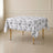White table overlay with black French toile pattern for elegant events.