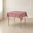 Dusty rose wrinkle-resistant square tablecloth 54"x54" on a table.