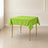 Apple green polyester square table overlay on a modern table.