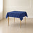 Navy blue wrinkle-resistant square tablecloth on a dining table.
