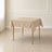 Nude wrinkle-resistant polyester tablecloth on a square table.
