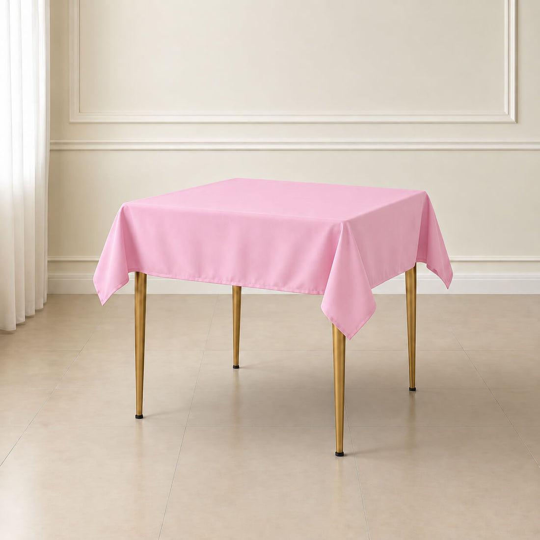 Pink wrinkle-resistant square tablecloth on a table.