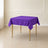 Purple polyester square tablecloth on a table.