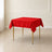 Red wrinkle-resistant square tablecloth on a table.