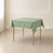 Sage green wrinkle-resistant square tablecloth on a dining table.