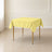 Yellow polyester square table overlay, 54"x54", wrinkle-resistant tabletop.