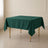 Hunter emerald green square tablecloth on a wooden table.