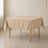 Nude polyester square table overlay 70"x70" on a table.