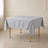 Silver wrinkle-resistant square tablecloth on a wooden table.
