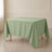 Sage green wrinkle-resistant polyester square tablecloth on a dining table.
