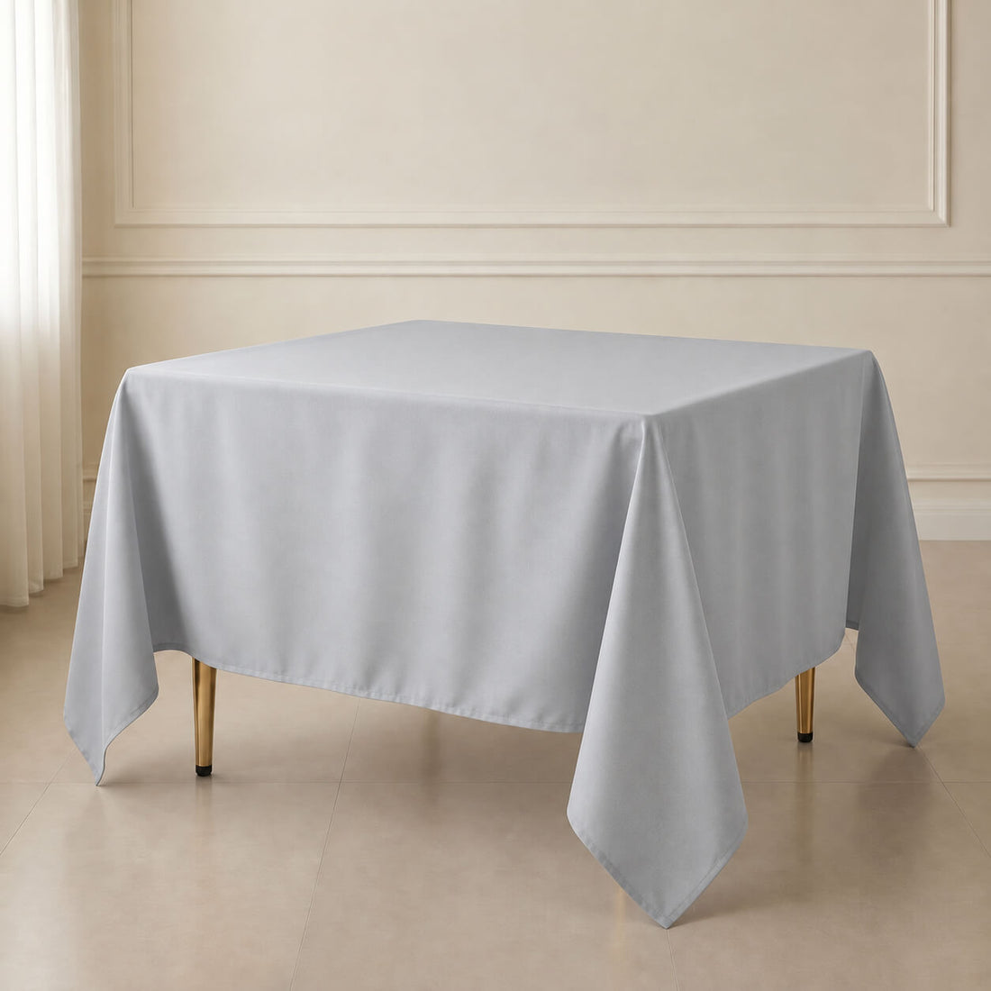 Silver polyester square tablecloth on a table, wrinkle-resistant and durable.