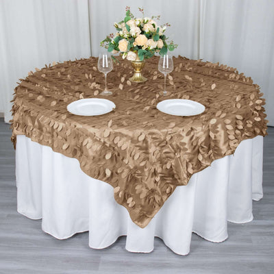 Elegant brown tablecloth with leaf texture, set for dining with flowers and glassware.