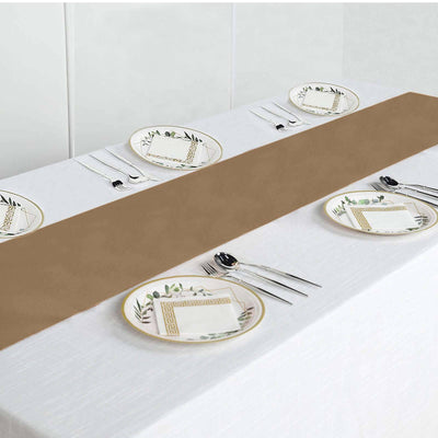 Elegant brown table runner on a white table with decorative plates and cutlery.