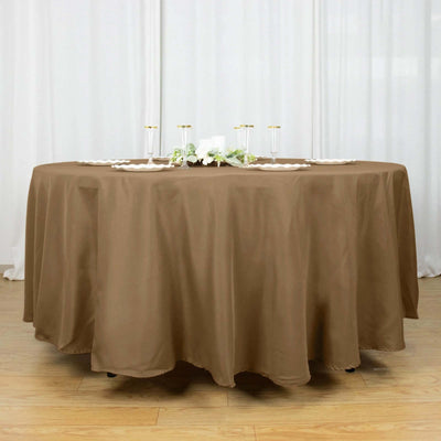 Round brown tablecloth on a circular table with elegant decor.