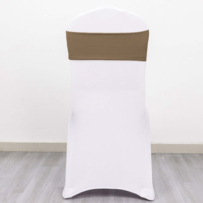 White chair with brown sash, studio shot on plain background.