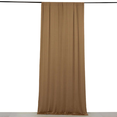 Brown curtain draped on a rod against a white backdrop