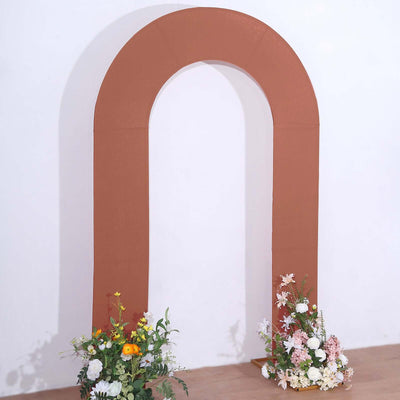 Brown arch backdrop with floral arrangements for events and photography.
