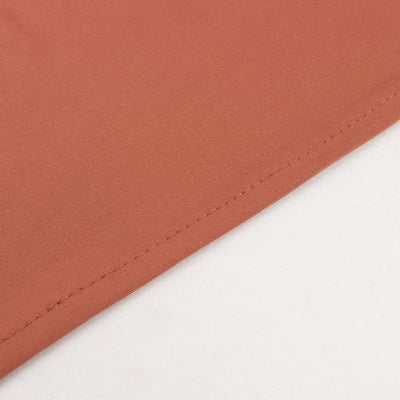 Close-up of soft coral fabric with neat stitching details.
