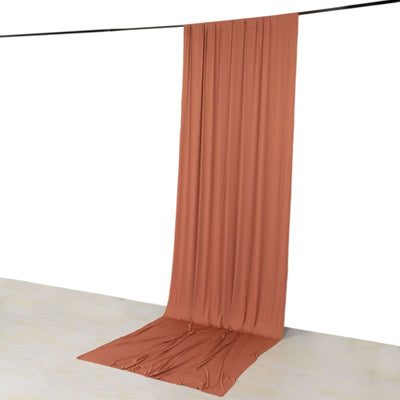 Brown backdrop fabric draped on the floor and hanging from a rod