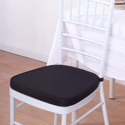 Black padded chair cushion on a white chiavari chair in a dining setting.