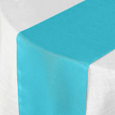 Turquoise table runner on a white tablecloth
