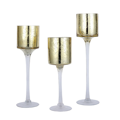 Gold mercury glass candle holders in three sizes on white background