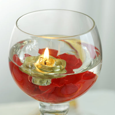 Floating candle in a glass bowl with rose petals and water.